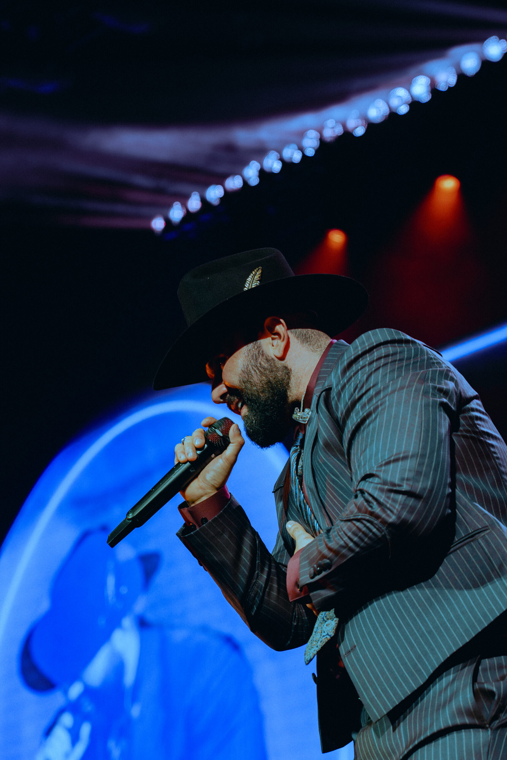 Carín León performing live on stage at Toyota Center in Houston